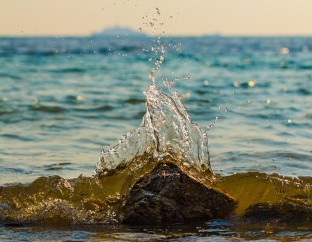 Stormy waves hitting rock on a tropical beachの写真素材