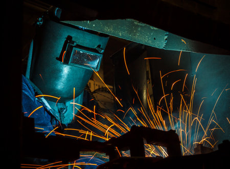 worker with protective mask welding metalの写真素材