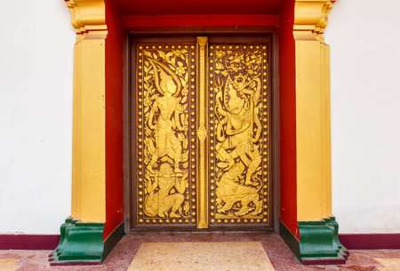Ancient Golden carving wooden window of Thai temple in Thailand.の写真素材