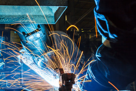 Worker with protective mask welding metal, knowledge to take action Gas welding car industry