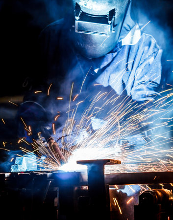 The movement of workers with protective mask welding metal.の写真素材