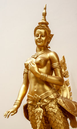 Kinnaree golden statue beautiful of white background in wat thailandの写真素材