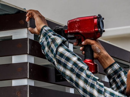 Gun construction shoot the nails in the wooden wallの写真素材