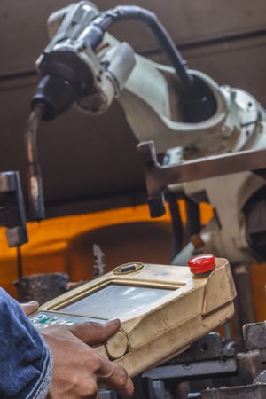 Programming robot welding and operating the robotic arm on industryの写真素材