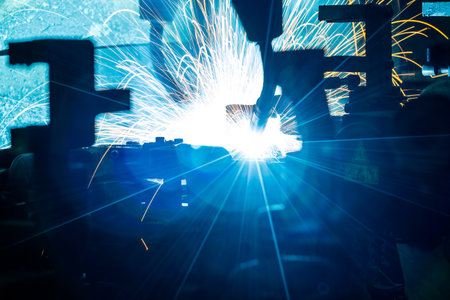 Light Welding robots movement in a car factory (manufacturing, industry, factory)の写真素材