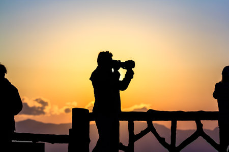 Silhouette of a photographer who was happy to shoot in the morning.の写真素材
