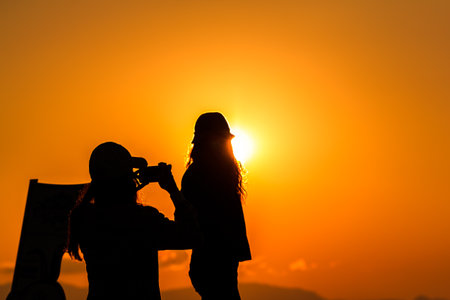 Shadow of people having fun in the sunrise in the morning.の写真素材