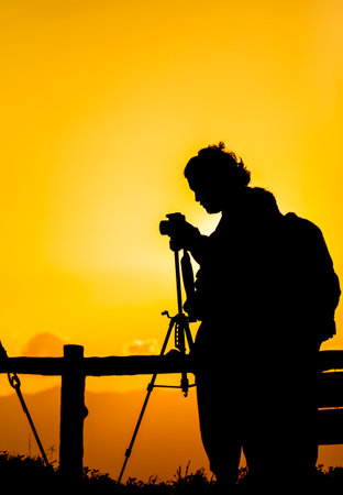 Silhouette of a photographer who was happy to shoot in the morning.の写真素材