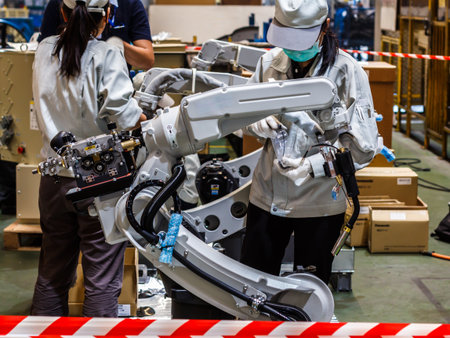 Assembly of industrial robots, People work with robots in industry.の写真素材