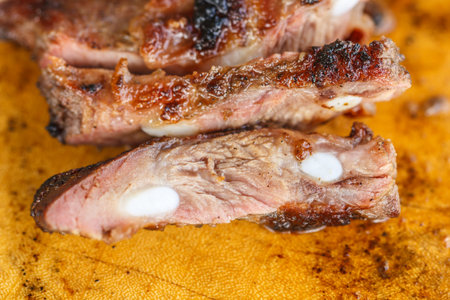 Beef steak cooked to medium rare on wooden backgroundの写真素材