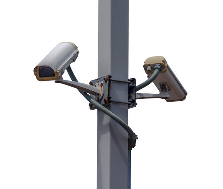 Surveillance camera on pole with white background