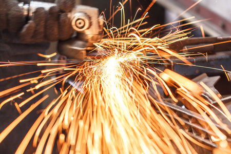 sparks while grinding in a steel factoryの写真素材