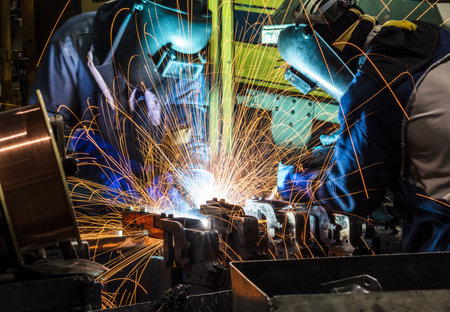 Team worker with protective mask welding metalの写真素材