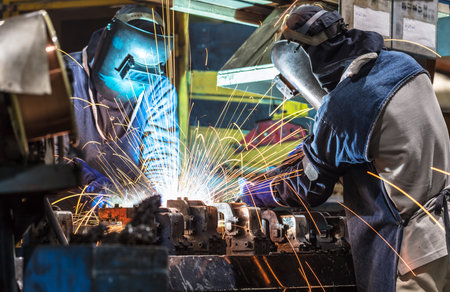 worker with protective mask welding metal industry