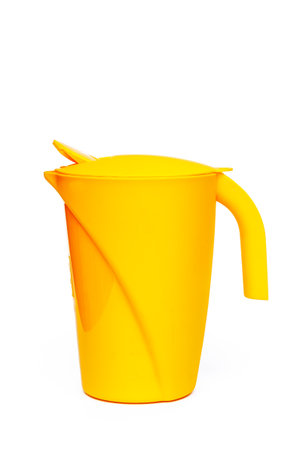 Yellow plastic glass on white backgroundの写真素材