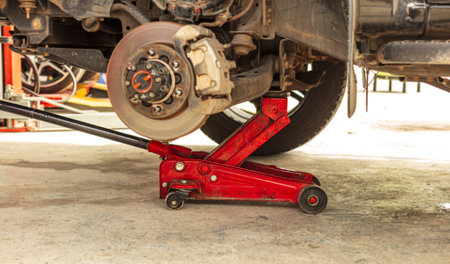 Red hydraulic floor lift jack for repairing the undercarriageの写真素材