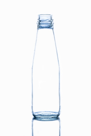 The front view of an empty glass bottle isolated on a white backgroundの写真素材