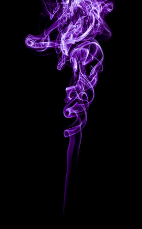 The smoke of incense stick are burning on the black background.の写真素材