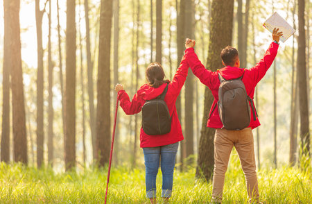 Men and women hiking with maps in the middle of natureの写真素材
