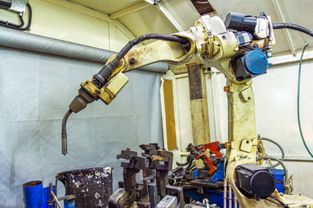 Industrial welding robots in production line manufacturer factoryの写真素材