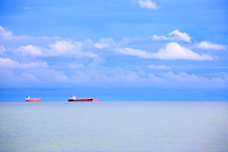 Long exposure shooting of small island boat and rock in smoky sea water with blue sky. Sky burst, blurred motionの写真素材