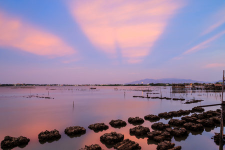 long exposure shooting of small island boat and rock in smoky sea water with blue sky, Sky burst,...