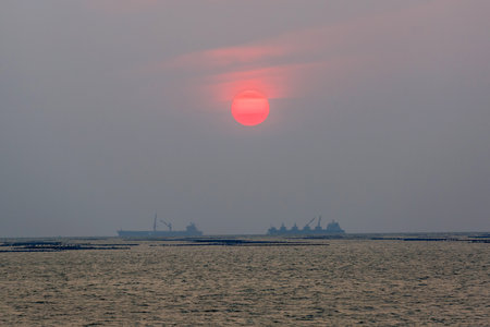 Orange sunset in dark gray skyの写真素材