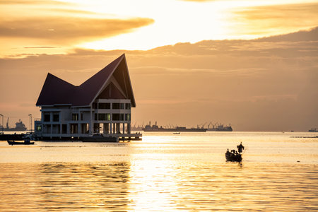 Silhouette fisherman on boat during sunset over a small island famous place of Chonburi Thailand called Koh-Loyの写真素材