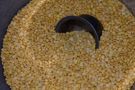 Toor dal in jar and half rising steel bowl in Toor Dal, Indian pigeon peas Dal