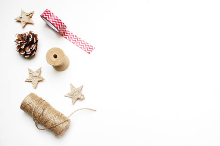 Christmas festive styled stock image composition. Pinecone, decorative tape, ribbon, rope, berries,...