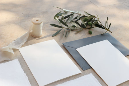 Closeup of summer wedding stationery mock-up scene. Blank greeting cards, invitations, envelopes,...