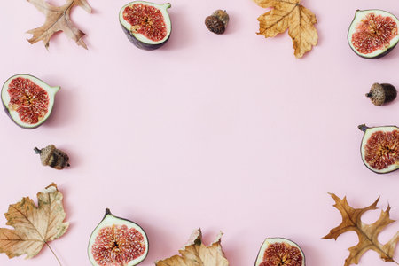 Autumn, fall composition of ripe purple figs. Fresh fruit, colorful maple and oak leaves and acorns...