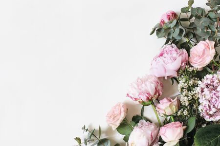 Feminine styled stock photo with pink roses, hydrangea, peony, flowers and eucalyptus leaves and branches isolated on white background. Flat lay, top view. Floral frame, botany decorative corner.の写真素材
