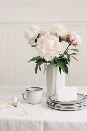 Wedding still life scene. Business, place card mockup scene, marble tray, cup of coffee an pink...