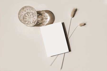 Modern summer stationery still life. Glass of water, cocktail, ong shadows and Lagurus ovatus grassy...