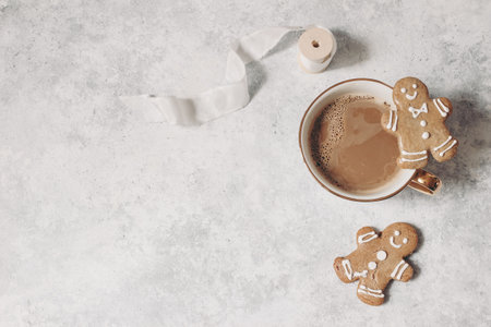 Decorative Christmas still life. Winter composition of gingerbread man shaped cookies and white silk...