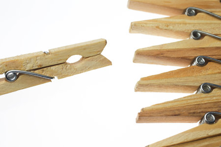 Wooden clothes pegs on a white background