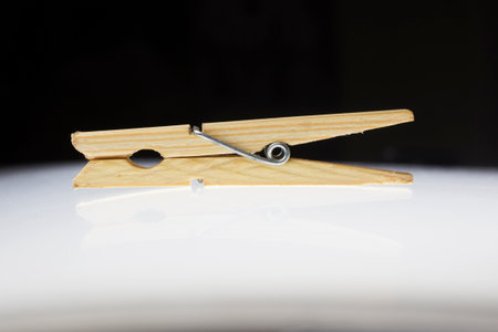 Wooden clothes peg on a white backgroundの写真素材