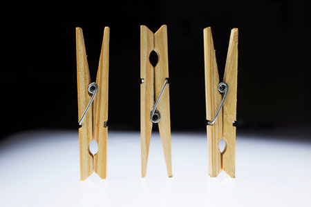 Wooden clothes pegs on a white backgroundの写真素材