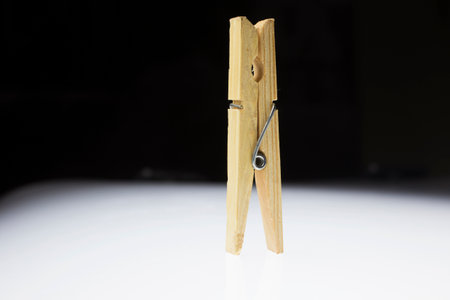 Wooden clothes peg on a white background