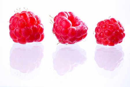 Fresh raspberries on a white background