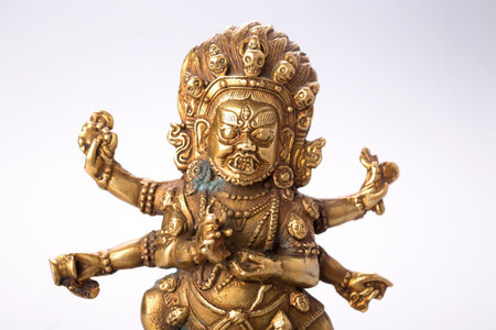 Buddhist figure with patina on a white background
