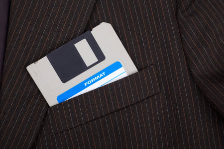 Old floppy disc in a suit chest pocket