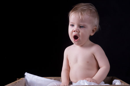 One year old boy is yawning, black backgroundの写真素材