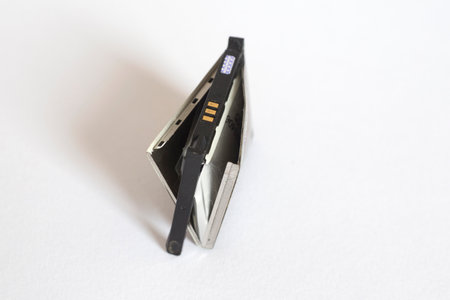 Old bloat battery for cellphone on a white background