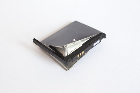 Old bloat battery for cellphone on a white background