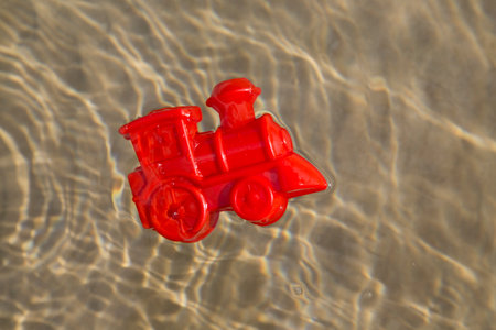 Plastic mould floating in a shallow sea, children toyの写真素材