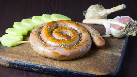Fresh sausage on a wooden chopping boardの写真素材