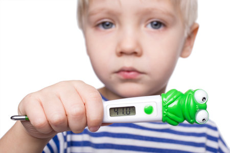 Young boy holding thermometer on a white backgroundの写真素材