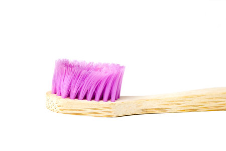 Used wooden toothbrush on a white backgroundの写真素材